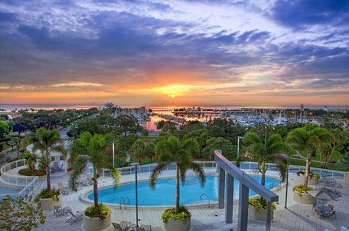 waterfront view of bayshore blvd and pool at sunset
